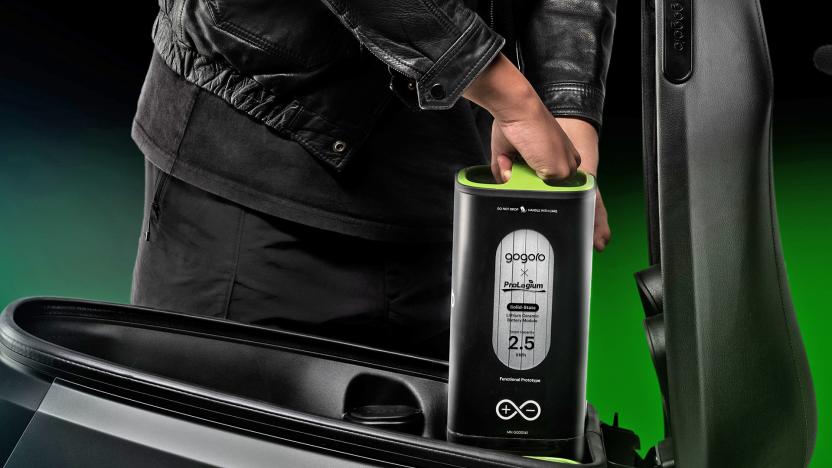 Gogoro swappable solid-state EV battery being dropped into place in a scooter but someone in a leather jacket.