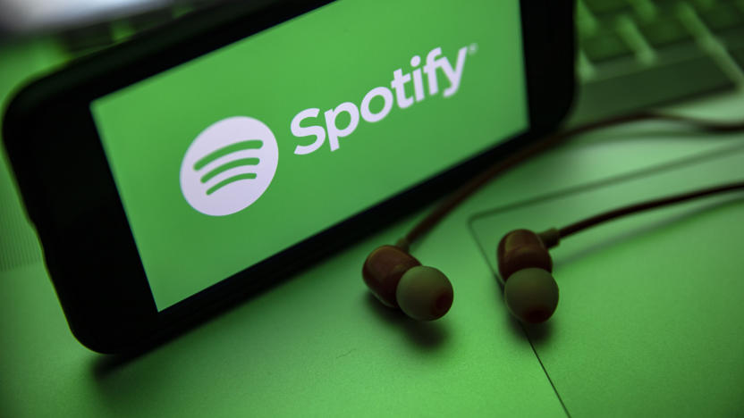 TURKEY - 2021/12/02: In this photo illustration the Spotify logo seen displayed on a smartphone screen near a pair of earphones. (Photo Illustration by Onur Dogman/SOPA Images/LightRocket via Getty Images)