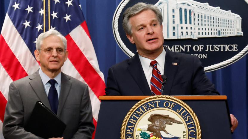 Federal Bureau of Investigation (FBI) Director Christopher Wray, with U.S. Attorney General Merrick Garland, answers a reporter's question at a news conference announcing charges against two Chinese nationals for trying to obstruct the prosecution of China's Huawei Technologies Co Ltd, and four others with trying to spy for Beijing, at the Justice Department in Washington, U.S. October 24, 2022.  REUTERS/Jonathan Ernst