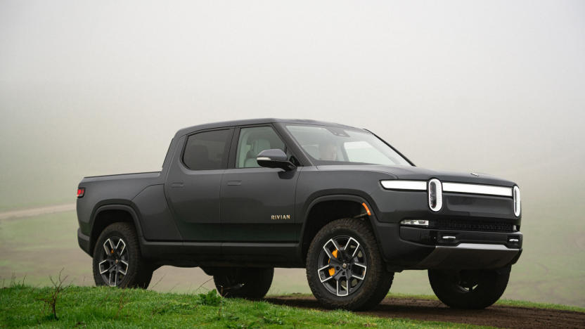 A dark gray truck parked on the grass.