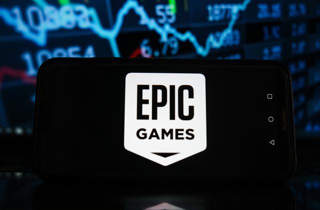 POLAND - 2021/03/21: In this photo illustration an Epic Games logo seen displayed on a smartphone with stock market percentages in the background. (Photo Illustration by Omar Marques/SOPA Images/LightRocket via Getty Images)