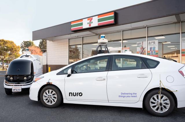 Nuro's self-driving Prius and R2 robot in front of a 7-Eleven store.