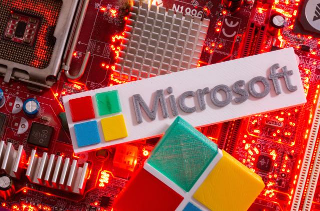 3D-printed Microsoft logos are seen on a computer motherboard in this picture illustration taken July 22, 2021. REUTERS/Dado Ruvic/Illustration