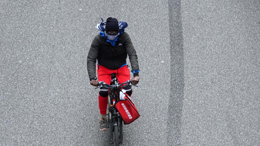 NEW YORK, NEW YORK - MAY 18: A Grubhub delivery person rides a bicycle on 42nd street during the coronavirus pandemic on May 18, 2020 in New York City. COVID-19 has spread to most countries around the world, claiming over 320,000 lives with over 4.8 million infections reported. (Photo by Noam Galai/Getty Images)