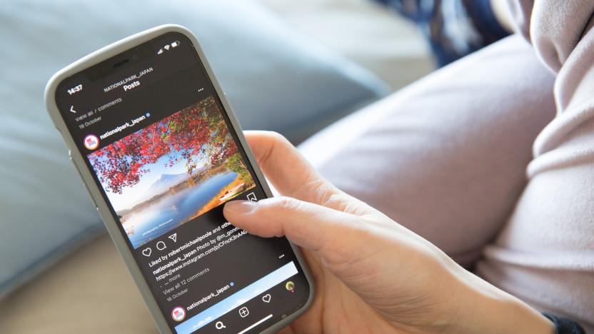 YOKOHAMA, KANAGAWA, JAPAN - 2020/10/31: In this photo illustration a woman holds the new iPhone 12 in her hands while checking the Instagram feed. (Photo Illustration by Stanislav Kogiku/SOPA Images/LightRocket via Getty Images)