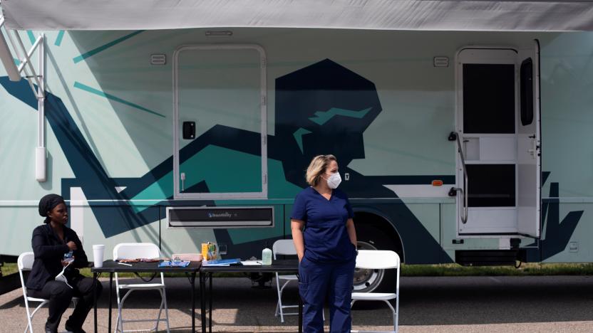 Nurses wait for people to come by to receive their coronavirus disease (COVID-19) vaccine at a mobile pop-up vaccination clinic hosted by the Detroit Health Department with the Detroit Public Schools Community District at East English Village Preparatory Academy in Detroit, Michigan, U.S., July 21, 2021.  REUTERS/Emily Elconin     TPX IMAGES OF THE DAY