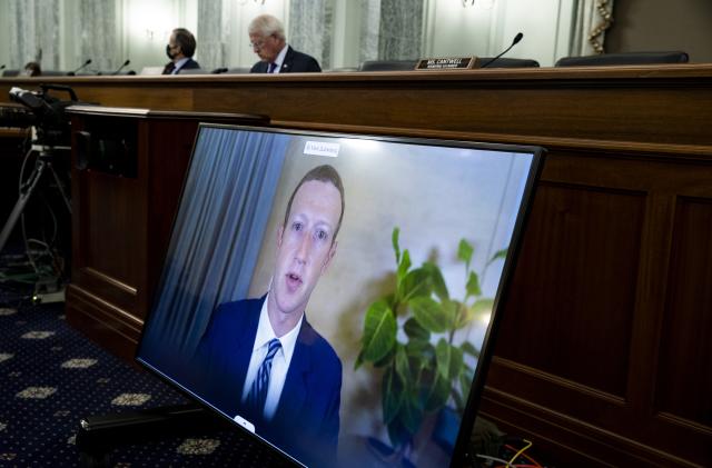 Facebook CEO Mark Zuckerberg appears on a screen as he speaks remotely during a hearing before the Senate Commerce Committee on Capitol Hill, Wednesday, Oct. 28, 2020, in Washington. The committee summoned the CEOs of Twitter, Facebook and Google to testify. (Michael Reynolds/Pool via AP)