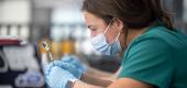 A nurse fills syringes of COVID-19 vaccine during a pop-up vaccination event in Louisville, Ky. (Jon Cherry/Getty Images)