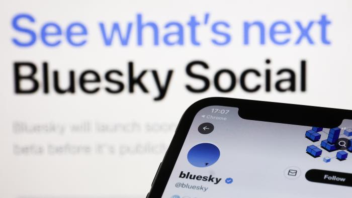 Bluesky Twitter account displayed on a phone screen and Bluesky Social website displayed on a screen in the background are seen in this illustration photo taken in Krakow, Poland on November 5, 2022. (Photo by Jakub Porzycki/NurPhoto via Getty Images)
