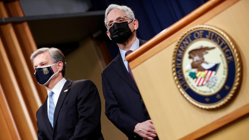 FBI Director Christopher Wray and U.S. Attorney General Merrick Garland face reporters as they announce charges against a suspect from Ukraine and a Russian national over a July ransomware attack on an American company, during a news conference at the Justice Department in Washington, U.S., November 8, 2021. REUTERS/Jonathan Ernst