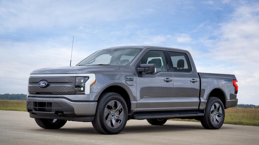 A gray Ford truck is on a brown road. 