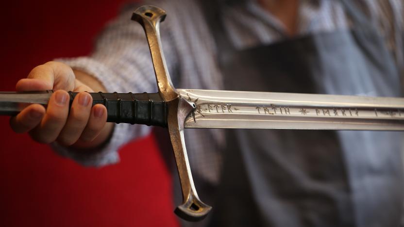 LONDON, ENGLAND - JULY 31:  A Bonhams employee holds 'Anduril' a prop sword belonging to Aragorn, hero of 'The Lord of the Rings' movie trilogy on July 31, 2014 in London, England. The sword, belonging to actor Sir Christopher Lee and estimated at $150,000-250,000, forms part of Bonhams 'There's No Place Like Hollywood' movie memorabilia auction taking place in New York on November 24, 2014.  (Photo by Peter Macdiarmid/Getty Images)