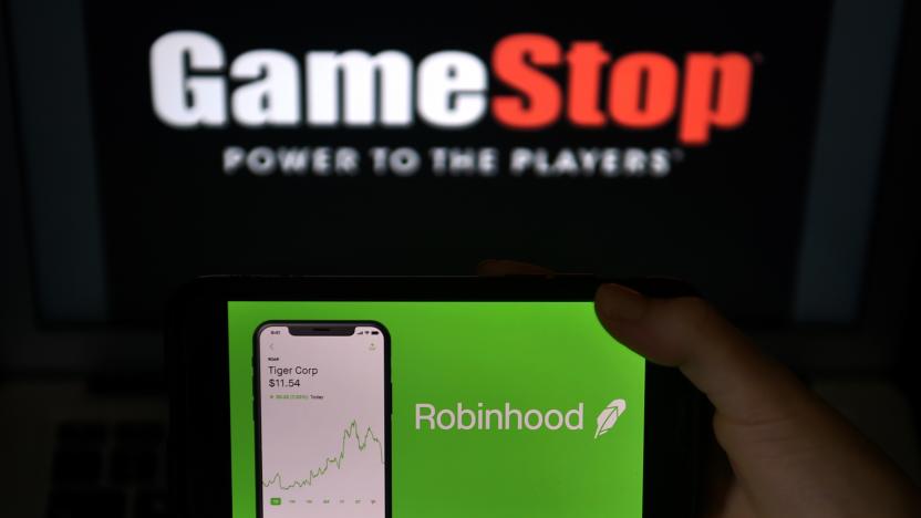 This photo illustration shows the logos of video grame retail store GameStop and trading application Robinhood in a computer and on a mobile phone in Arlington, Virginia on January 28, 2021. - An epic battle is unfolding on Wall Street, with a cast of characters clashing over the fate of GameStop, a struggling chain of video game retail stores. The conflict has sent GameStop on a stomach-churning ride with amateur investors taking on the financial establishment in the mindset of the Occupy Wall Street movement launched a decade ago. (Photo by Olivier DOULIERY / AFP) (Photo by OLIVIER DOULIERY/AFP via Getty Images)