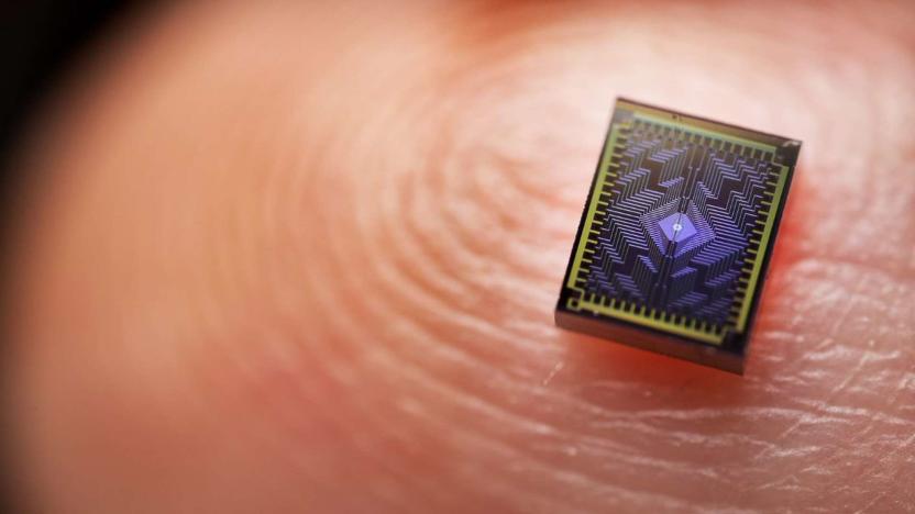 Macro photo of a very small processor on a human finger, where you can see the details of the fingerprint.