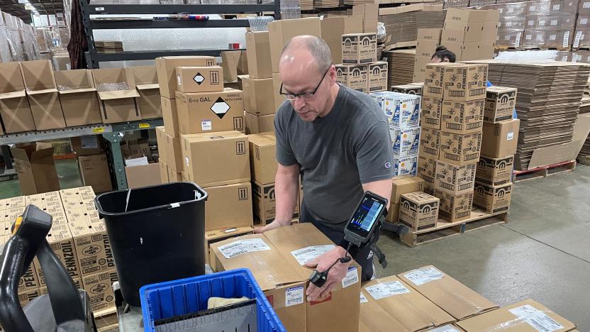 A worker uses an arm-mounted scanner to pack an order at Kem Krest's warehouse in Elkhart, Indiana, U.S. March 24, 2022. Picture taken March 24, 2022. REUTERS/Timothy Aeppel