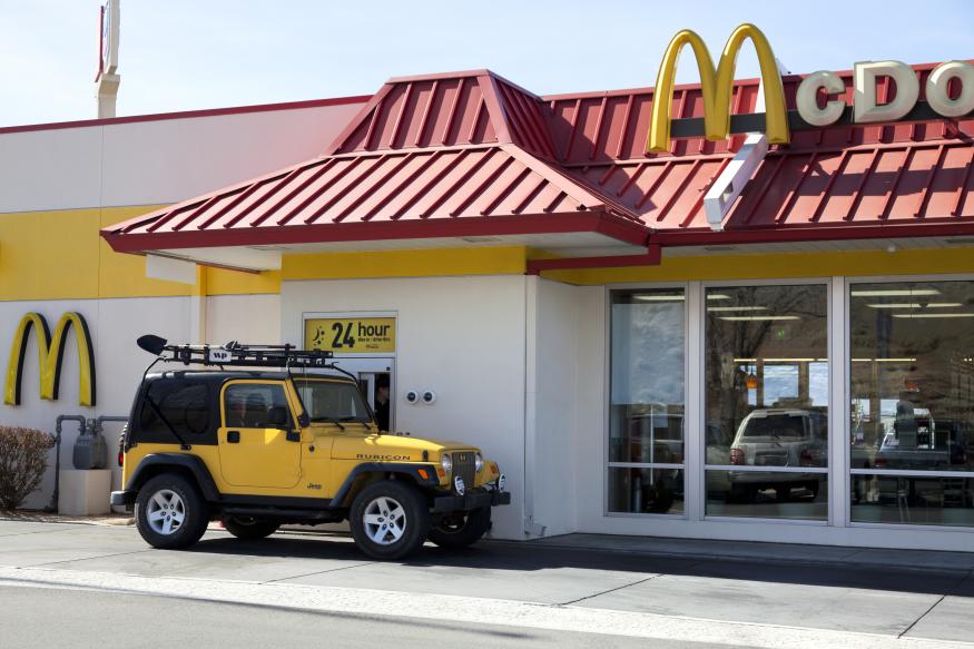 Salt Lake City, USA - February 26, 2013: Mcdonalds Drive thru service is amount one of the popular service in fast food chain restuarants, many stores open 24 hours. A yellow jeep pick up order at the drive thru window.