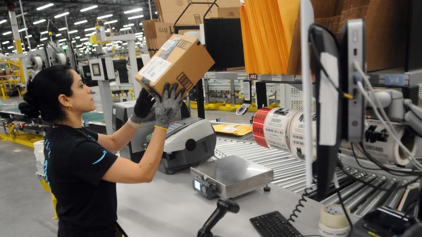 An Amazon associate processes a package for delivery at the newest Amazon Robotics fulfillment center during its first public tour on April 12, 2019 in the Lake Nona community of Orlando, Florida. The over 855,000 square foot facility opened on August 26, 2018 and employs more than 1500 full-time associates who pick, pack, and ship customer orders with the assistance of hundreds of robots which can lift as much as 750 pounds and drive 5 feet per second.  (Photo by Paul Hennessy/NurPhoto via Getty Images)