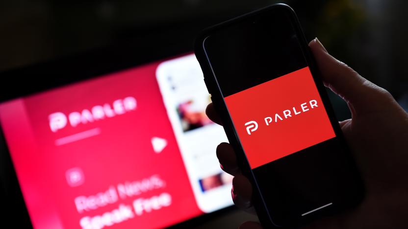 This illustration picture shows social media application logo from Parler displayed on a smartphone with its website in the background in Arlington, Virginia on July 2, 2020. - Amid rising turmoil in social media, recently formed social network Parler is gaining with prominent political conservatives who claim their voices are being silenced by Silicon Valley giants. Parler, founded in Nevada in 2018, bills itself as an alternative to "ideological suppression" at other social networks. (Photo by Olivier DOULIERY / AFP) (Photo by OLIVIER DOULIERY/AFP via Getty Images)