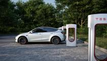 A Tesla car charges at a Supercharger station.