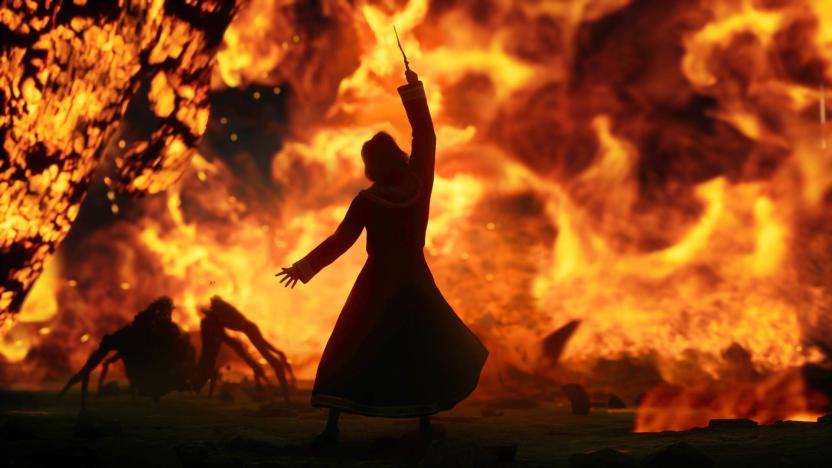 In this screenshot from the video game Hogwarts Legacy, a wizard or witch stands in front of a wall of fire and lifts their wand to the sky, while an acromantula scurries in the midground.
