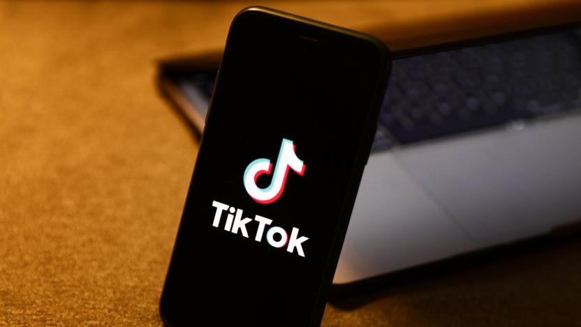 TikTok logo displayed on a phone screen and a laptop are seen in this illustration photo taken in Krakow, Poland on August 10, 2022. (Photo by Jakub Porzycki/NurPhoto via Getty Images)