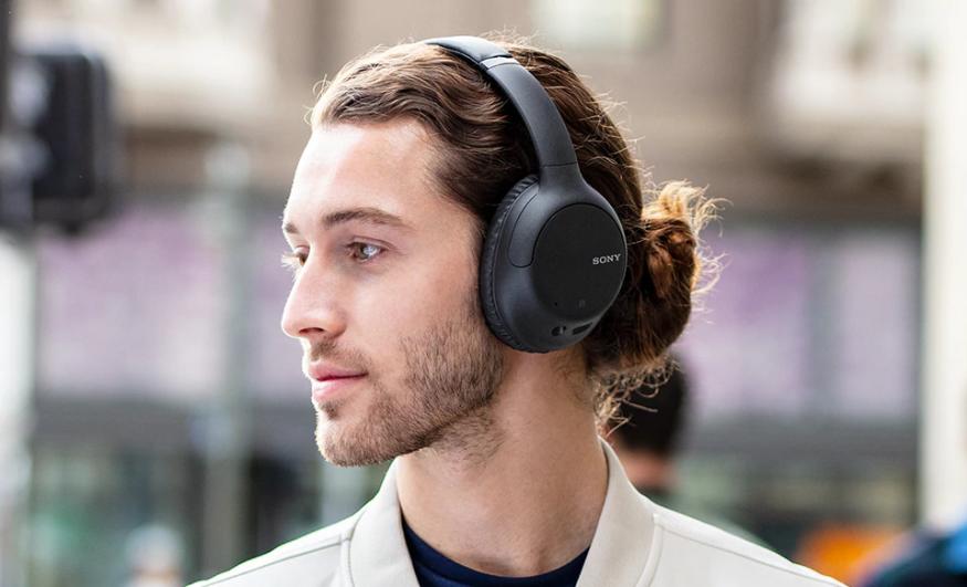 A person wearing Sony's WH-CH710N headphones.