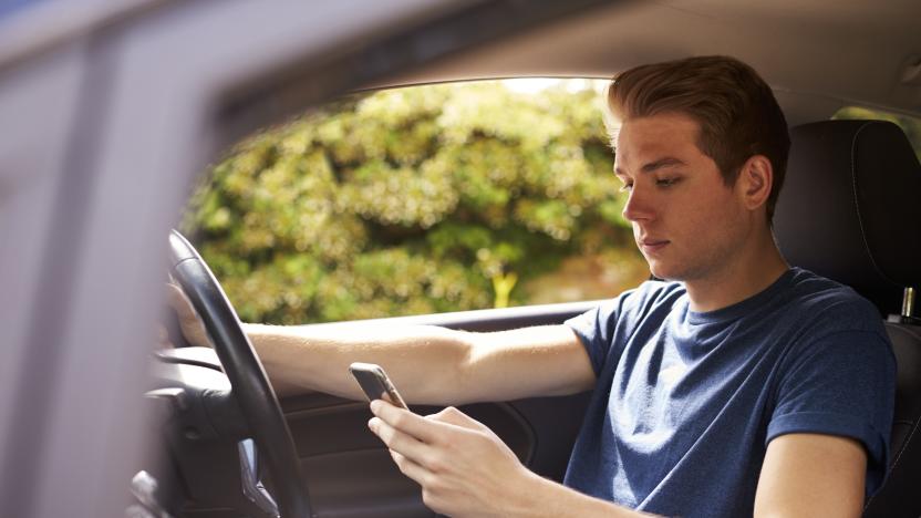 Young Man Sending Text Message Whilst Driving