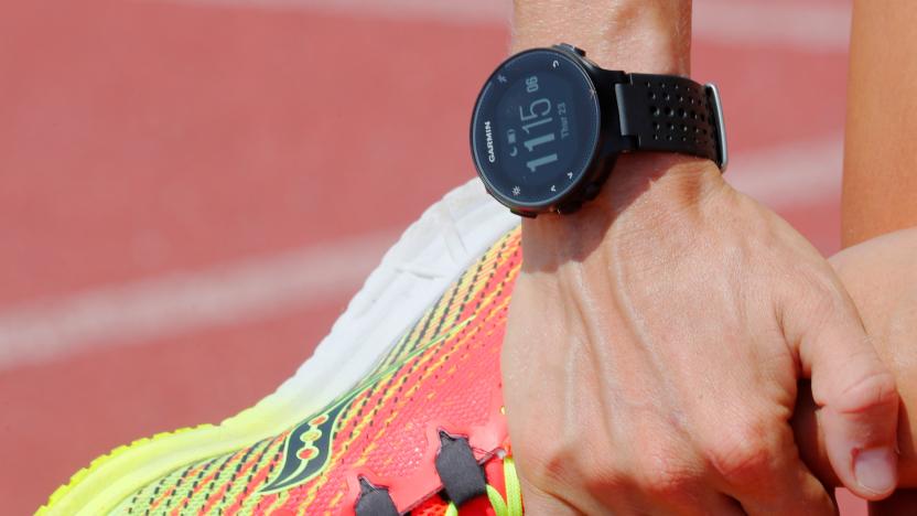 A runner wearing a Garmin smart watch, a device which Stanford professor Michael Snyder suggests might be used to help detect early coronavirus disease (COVID-19) infection, stretches before a workout in Cambridge, Massachusetts, U.S., July 23, 2020.   REUTERS/Brian Snyder