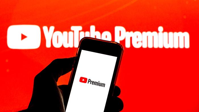 BARCELONA, CATALONIA, SPAIN - 2021/07/26: In this photo illustration a YouTube Premium logo seen displayed on a smartphone and in the background. (Photo Illustration by Thiago Prudêncio/SOPA Images/LightRocket via Getty Images)