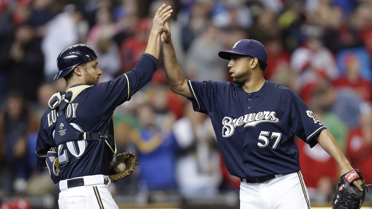 Brewers catcher Martin Maldonado knocks the cover off a baseball 