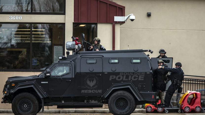 BOULDER, CO - MARCH 22: SWAT teams advance through a parking lot as a gunman opened fire at a King Sooper's grocery store on March 22, 2021 in Boulder, Colorado. Ten people, including a police officer, were killed in the attack.   (Photo by Chet Strange/Getty Images)