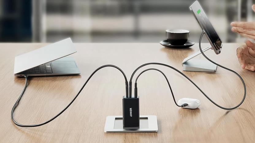 A charger on a table connected to multiple devices. 