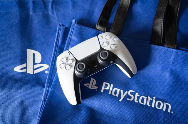 Bangkok, Thailand - December 27, 2022: Playstation 5's DualSense game controller and Playstation logo.