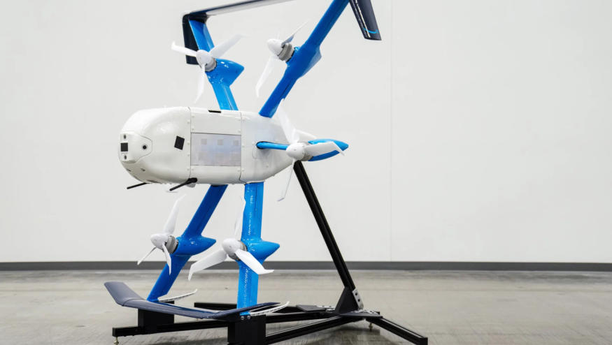 A white and blue drone propped against a stand.