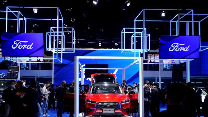 Visitors check a Ford Mustang Mach-E electric vehicle (EV) displayed at the Ford booth during a media day for the Auto Shanghai show in Shanghai, China April 19, 2021. REUTERS/Aly Song