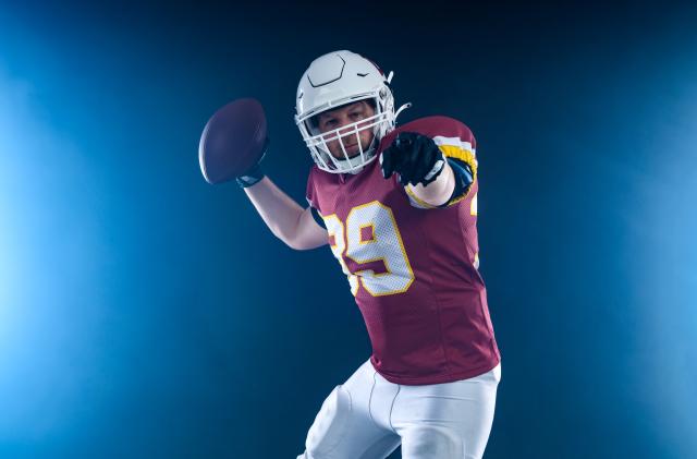 American football player in action. Template for a sports magazine on the theme of American football with copy space. Mockup for betting advertisement.