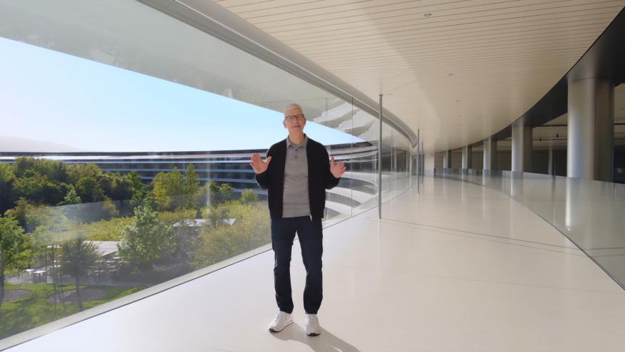 Tim Cook standing in a sleek hallway inside Apple Park.