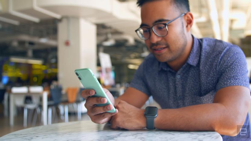 Using an Apple iPhone 11 at a table