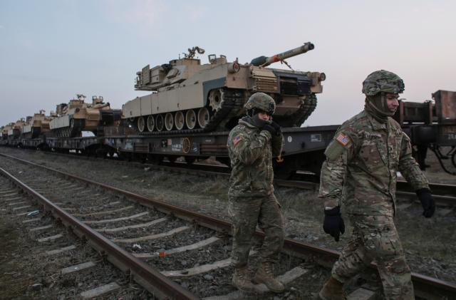 US soldiers walk next to M1 Abrams tanks at the Mihail Kogalniceanu Air Base,  Romania, February 14, 2017. Inquam Photos/Octav Ganea/via REUTERS ATTENTION EDITORS - THIS IMAGE WAS PROVIDED BY A THIRD PARTY. EDITORIAL USE ONLY. ROMANIA OUT. NO COMMERCIAL OR EDITORIAL SALES IN ROMANIA