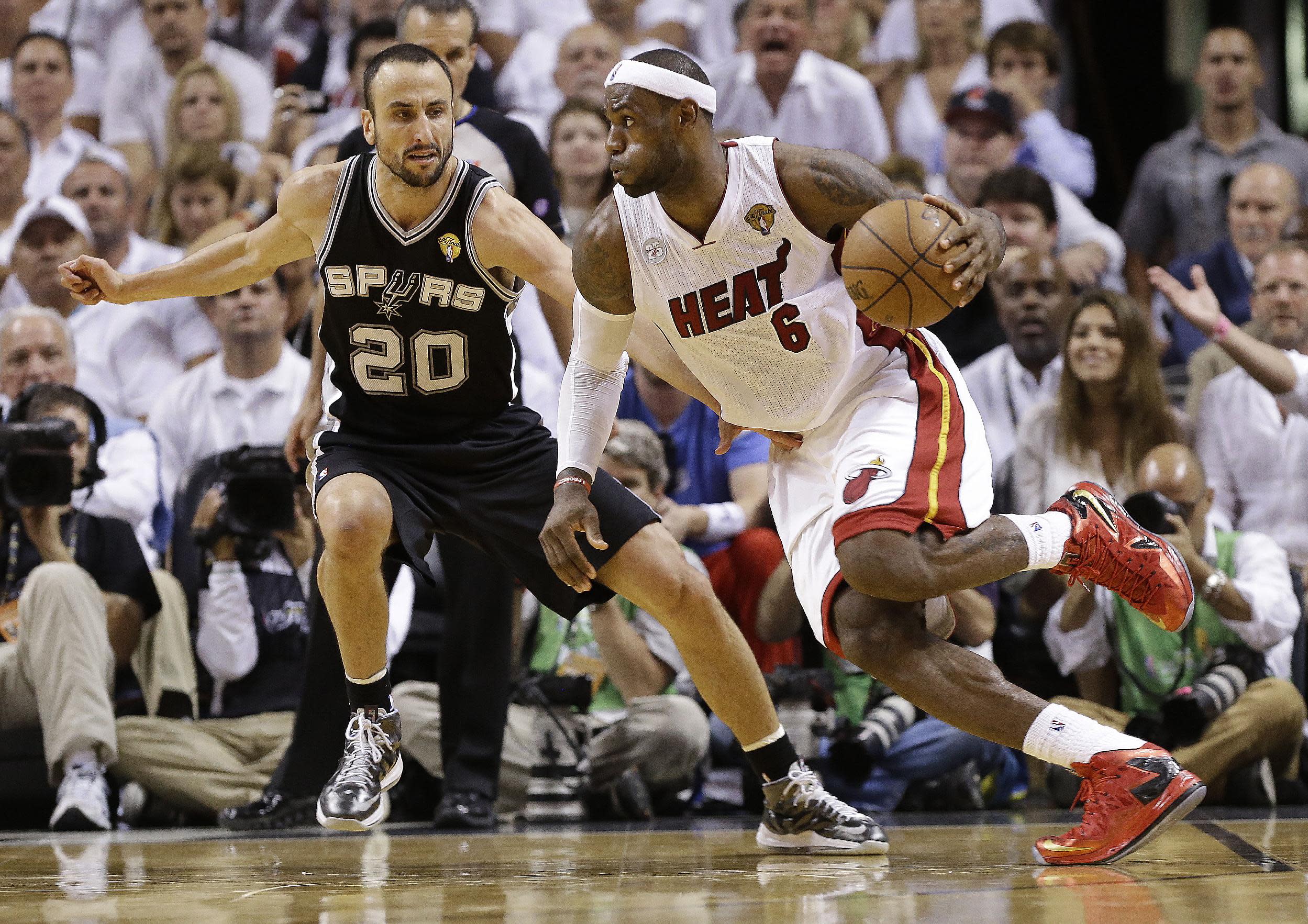 AP PHOTOS: Heat's overtime escape to defend title