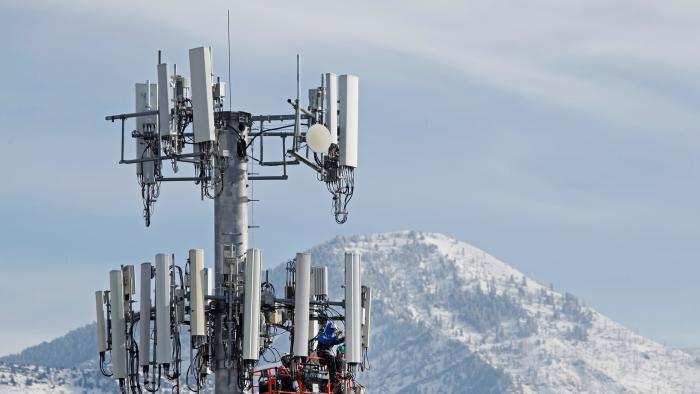 TOPSHOT - A contract crew for Verizon, works on a cell tower to update it to handle the new 5G network in Orem, Utah on December 10,  2019. - The new 5G cellular network will substantially increase cellular network speeds, opening up new markets for business and individuals. (Photo by GEORGE FREY / AFP) (Photo by GEORGE FREY/AFP via Getty Images)