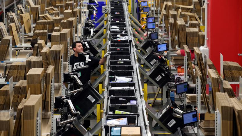 Workers process purchased orders at a packaging area inside Amazon distribution center in El Prat de Llobregat, near Barcelona, Spain, March 15, 2018. REUTERS/Albert Gea     TPX IMAGES OF THE DAY