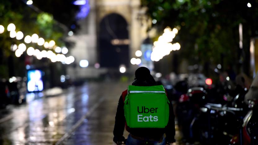 MILAN, ITALY - OCTOBER 26:  A Uber Eats food delivery rider rides along a street in Corso Sempione on October 26, 2020 in Milan, Italy. To combat a second wave of COVID-19 cases, Italy introduced new restrictions, including the 6pm closure of bars and restaurants and complete closure of gyms, swimming pools, cinemas, theatres and ski stations.  (Photo by Pier Marco Tacca/Getty Images)