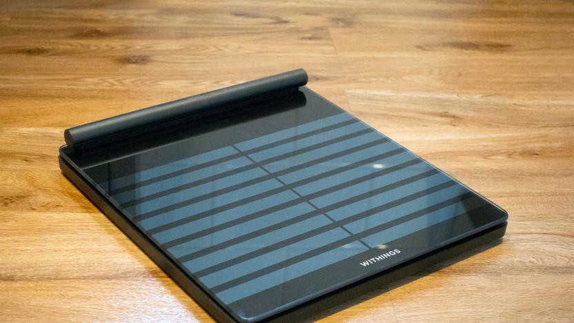 Image of Withings' Body Scan connected health station scale at an angle against a wooden floor in my bathroom.