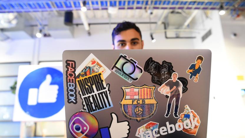 Facebook employee Mohamed Almari works from his laptop decorated in various Facebook stickers at the company's corporate headquarters campus in Menlo Park, California, on October 23, 2019. (Photo by Josh Edelson / AFP) (Photo by JOSH EDELSON/AFP via Getty Images)