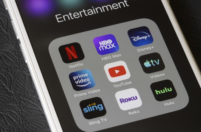 Portland, OR, USA - Feb 2, 2021: Assorted streaming apps are seen on an iPhone, including Netflix, HBO Max, Disney Plus, Amazon Prime Video, YouTube, Apple TV, Sling TV, Roku, and Hulu.