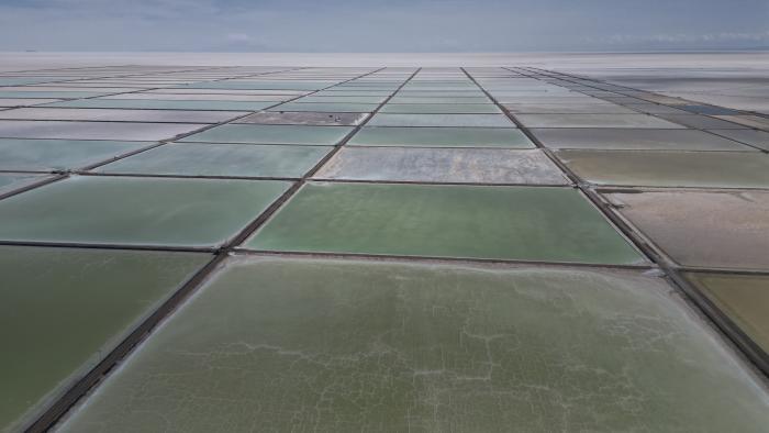 Aerial view of the salt recovery pools in different degrees of evaporation at an industrial plant that produces lithium carbonate to manufacture lithium batteries, after the plant's opening ceremony in the Uyuni salt desert on the outskirts of Llipi, Bolivia, Friday, Dec. 15, 2023. (AP Photo/Juan Karita)