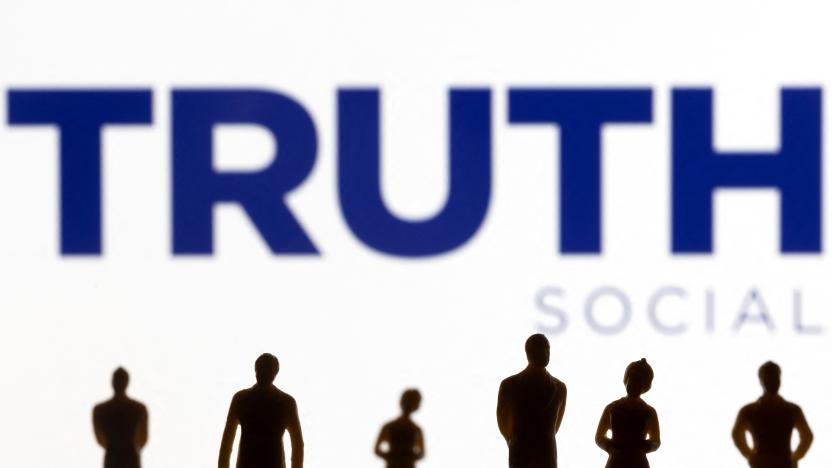 The Truth social network logo is seen displayed behind figurines in this picture illustration taken February 21, 2022. REUTERS/Dado Ruvic/Illustration