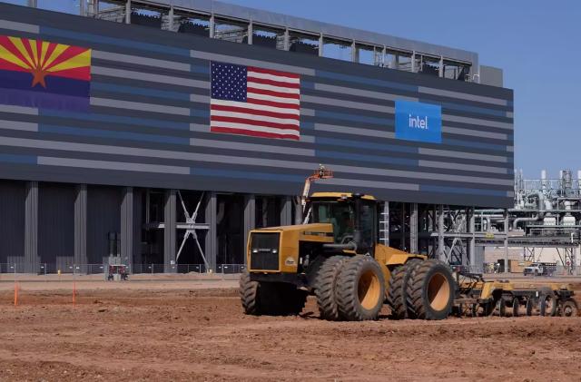 A construction truck in front of a building with the American flag and Intel's logo.