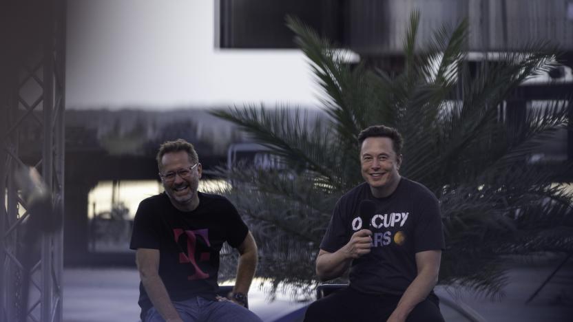 BOCA CHICA BEACH, TX - AUGUST 25: SpaceX founder Elon Musk and T-Mobile CEO Mike Sievert on stage during a T-Mobile and SpaceX joint event on August 25, 2022 in Boca Chica Beach, Texas. The two companies announced plans to work together to provide T-Mobile cellular service using Starlink satellites. (Photo by Michael Gonzalez/Getty Images)